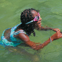 Girl in goggles in water