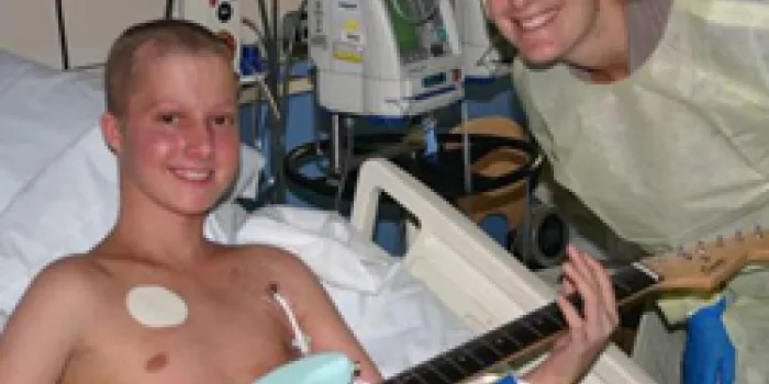 Vanya Green and a teenage boy with guitar for music therapy
