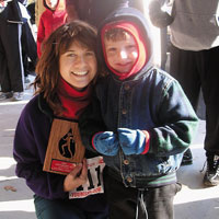 Mom holding plaque standing next to young son