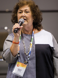Jeanne White-Ginder holding a microphone
