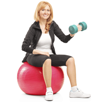 Woman sitting on red exercise ball holding a dumbbell