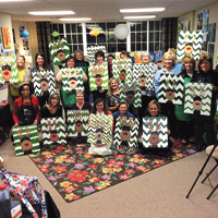Group photo of members of HSC’s Ladies Support Group showing off their holiday crafts