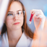 Researcher examining a sample