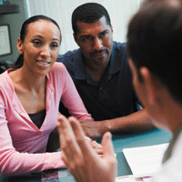 Couple talking to doctor