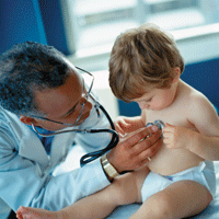 Doctor examining toddler with stethoscope