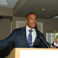 Meteorologist Mike Woods at podium speaking