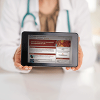 Hands holding device showing medical website