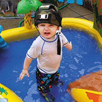 Child standing in inflatable kiddie pool