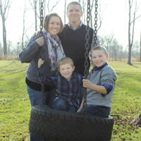 Family outside, kids on tire swing