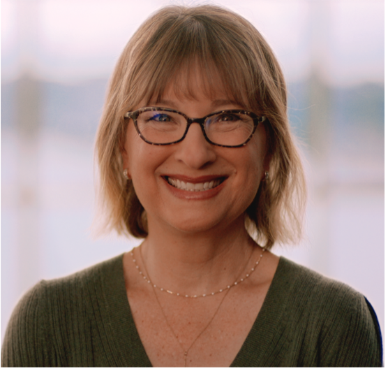 A close up photo of Suzanne smiling.