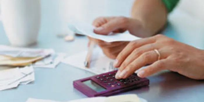 Using a calculator to add up medical expenses