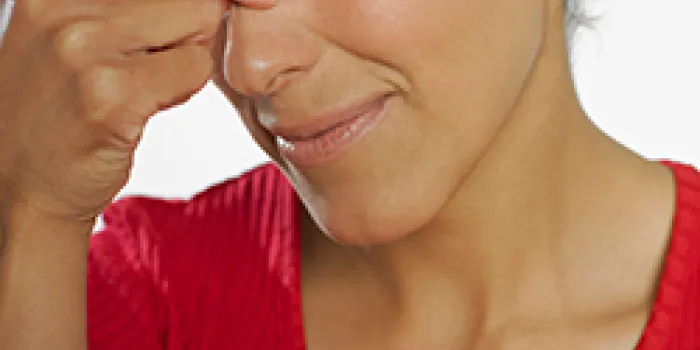 Woman squeezing bridge of nose
