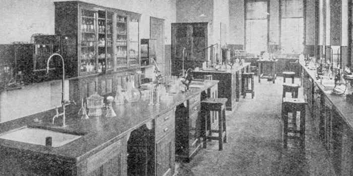 An old black and white photo of a research lab filled with supplies