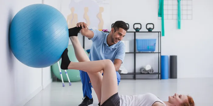 Physical therapist working with patient