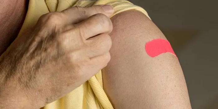 arm showing a band-aid where a vaccine was given