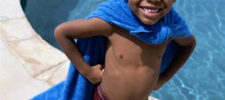 Boy with hemophilia near a pool