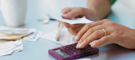 Using a calculator to add up medical expenses