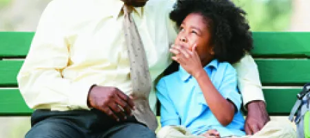 Dad and son sitting on a bench