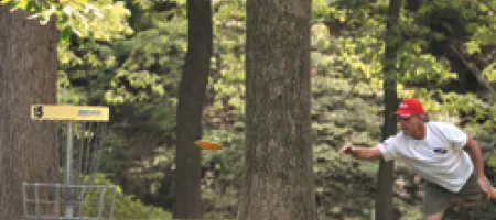 Young man playing disc golf