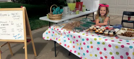 Amelia Mickeliunas hosts a lemonade stand in Omaha, Nebraska, to raise money for NHF.
