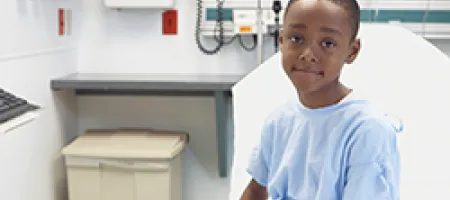 Boy sitting on hospital bed