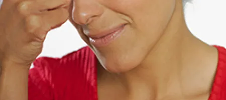 Woman squeezing bridge of nose
