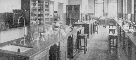 An old black and white photo of a research lab filled with supplies