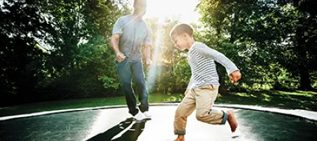 Man and boy actively playing outside