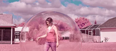 A woman walking outside in a bubble.