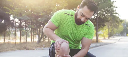 Man holding his knee for joint pain