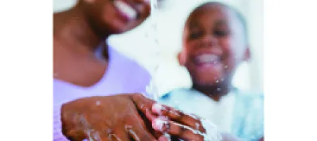 Mother and son washing hands