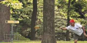 Young man playing disc golf