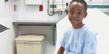 Boy sitting on hospital bed