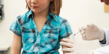 Girl receiving shot at doctor's office